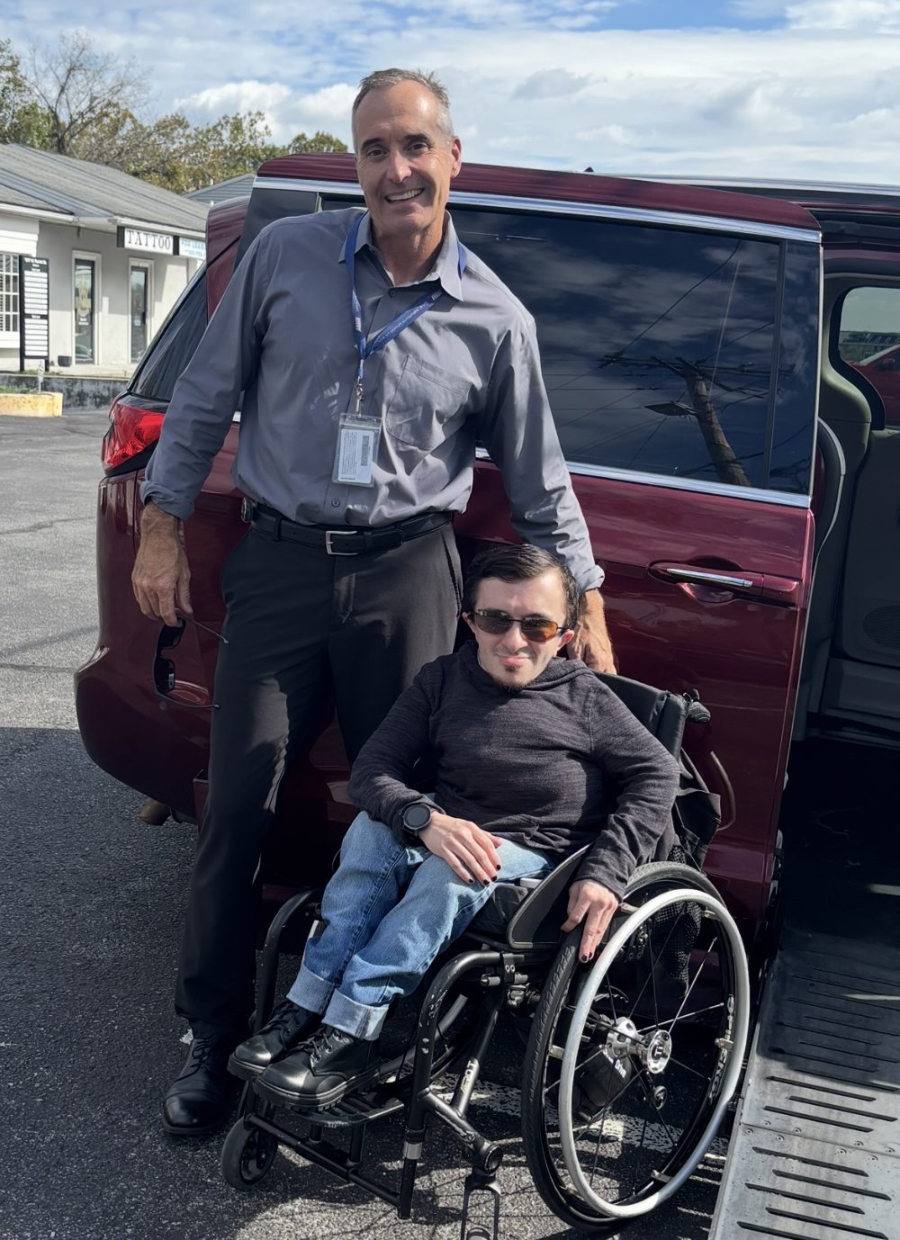 Tim with Ricky in his wheelchair outside his adaptive van